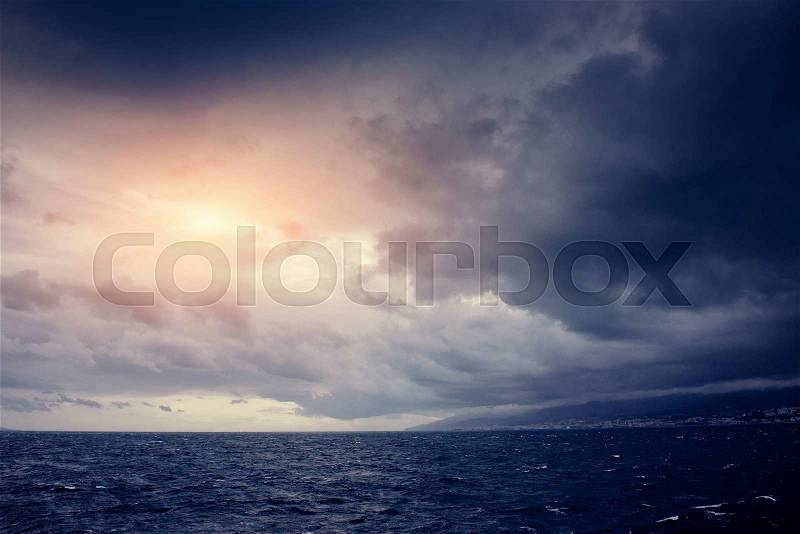 Cumulus clouds over the sea, stock photo