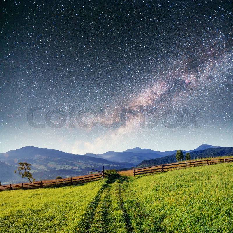 Fantastic starry sky stacks and traditional mountain villages. Carpathians, Ukraine, stock photo