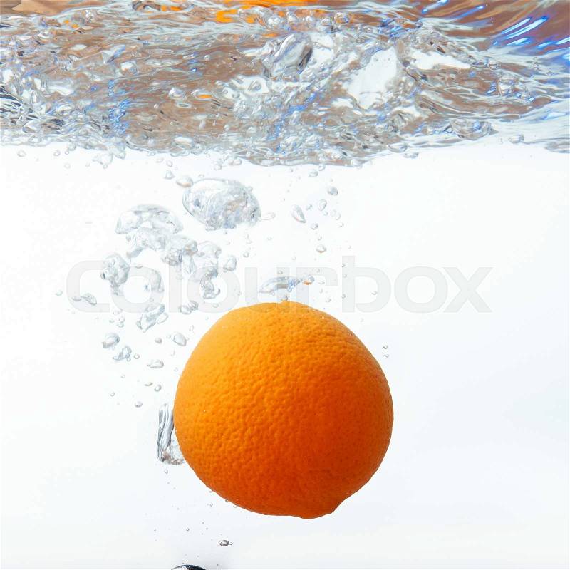 Orange in spray of water. Orange with splash on white background, stock photo