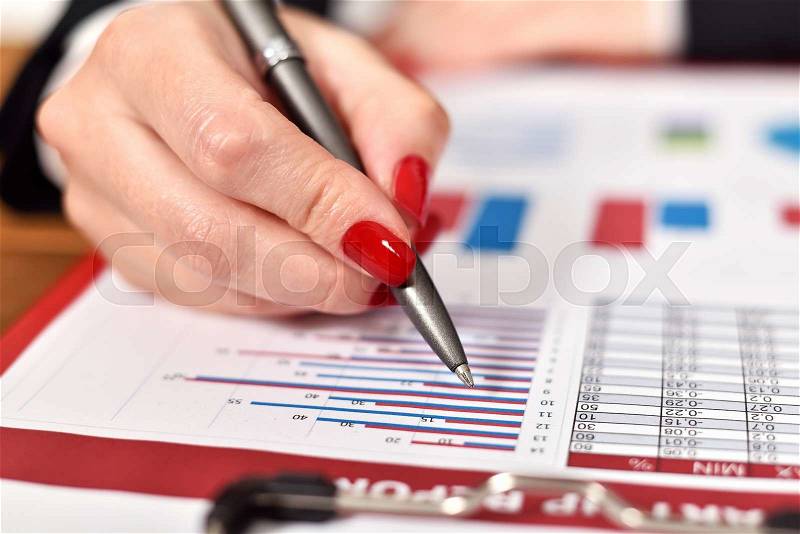 Woman hand checks start up report. close up, stock photo