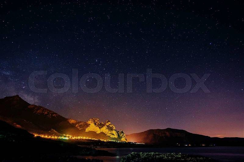 Starry Sky over the city by the sea, stock photo