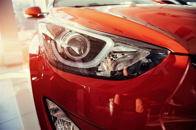 Headlights and hood of sport red car, stock photo