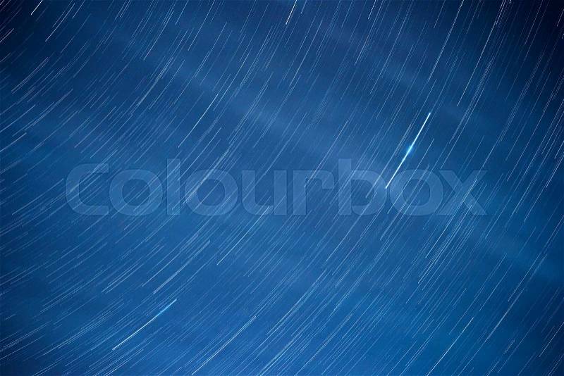 Movement of the stars in the night sky, textural background, stock photo