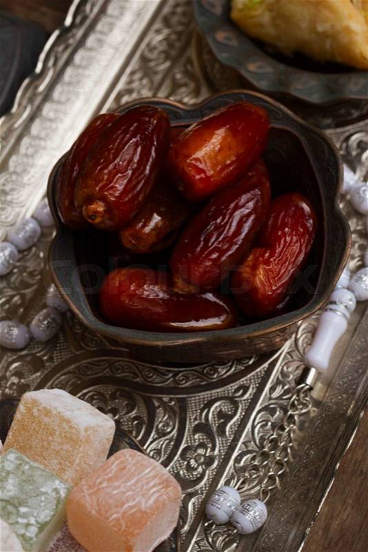 Date fruit with rosemary on metal oriental traditional tray, stock photo