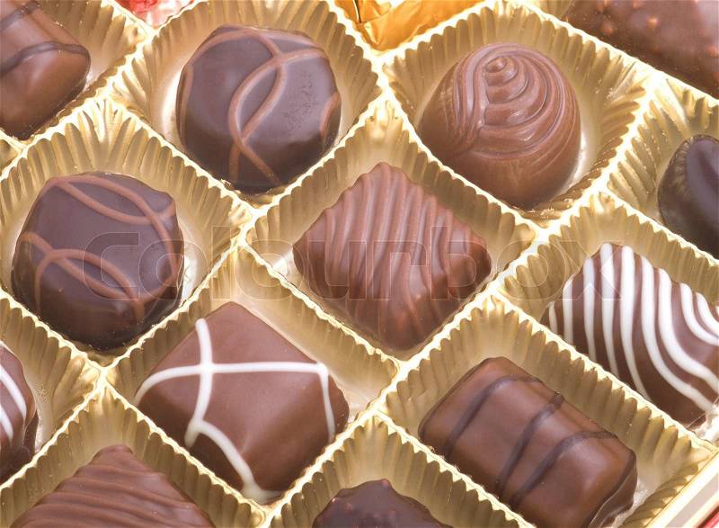 Assortment chocolate pralines in a golden box, stock photo