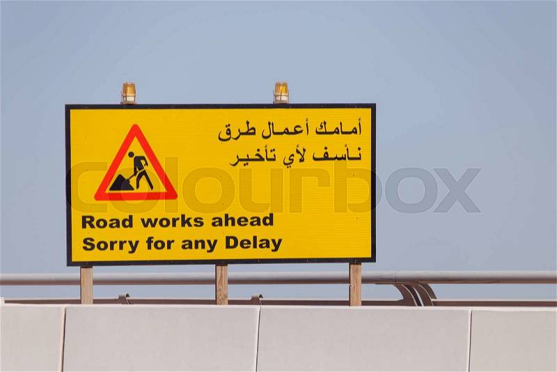 Road sign Road Works Ahead in English and Arabic, stock photo