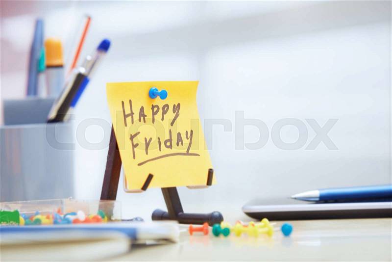 Friday text on adhesive note at office, stock photo
