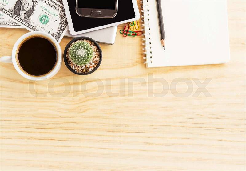 Vintage office desk with notebooks,cactus,smart phone and a cup of coffee. Top view with copy space, stock photo