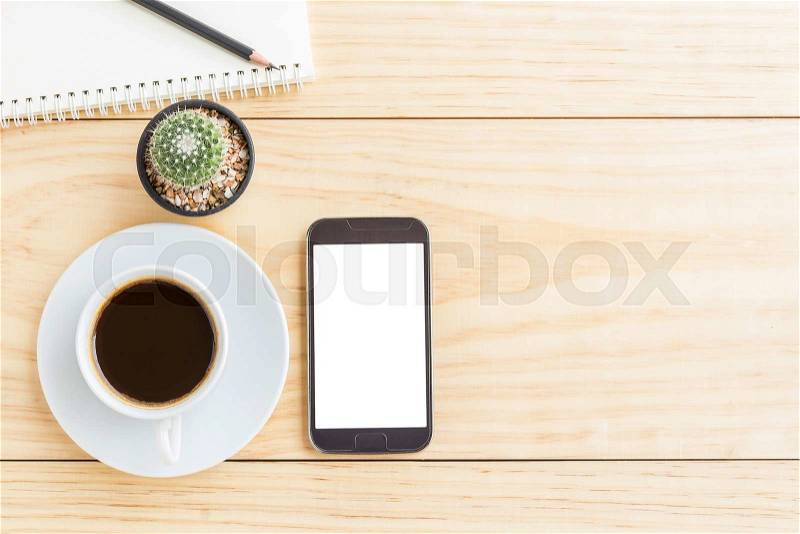Vintage office desk table with smartphone,notebooks, pencil and a cup of coffee. Top view with copy space, stock photo
