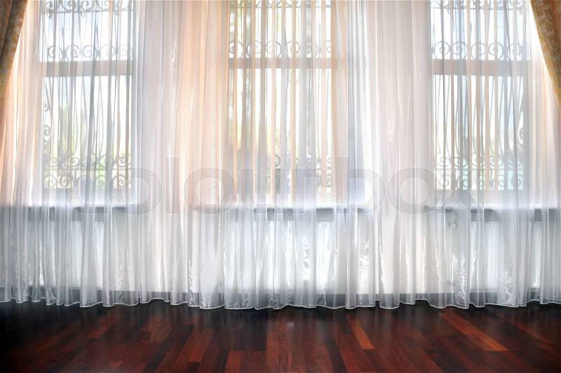 Room window with white, yellow and orange curtains, stock photo