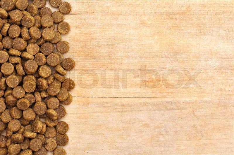 Dog food on wooden table background, stock photo