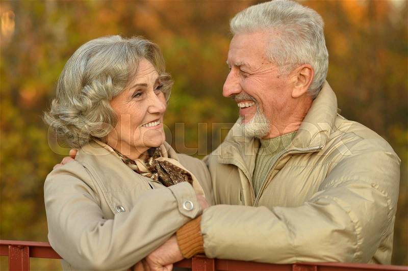 Happy beautiful Senior couple in autumn park, stock photo