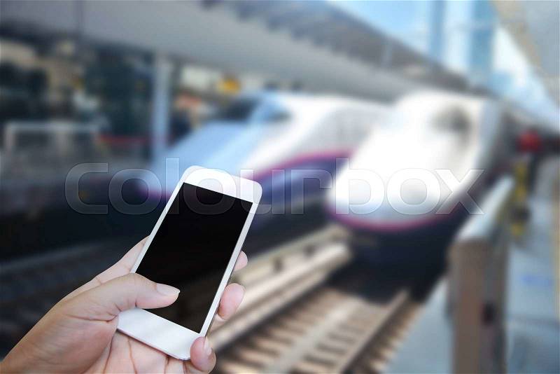 Closed up hand of man touch screen. Train station background, stock photo