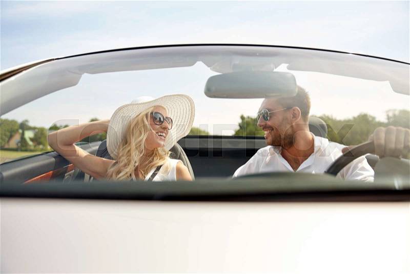 Road trip, travel, dating, couple and people concept - happy man and woman driving in cabriolet car outdoors, stock photo