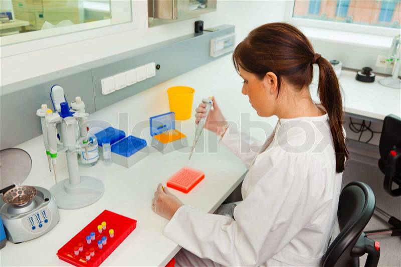 A woman in laboratory research. Research in the research laboratory, stock photo