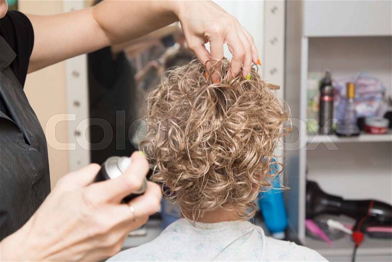 Female hair lacquer in a beauty salon, stock photo
