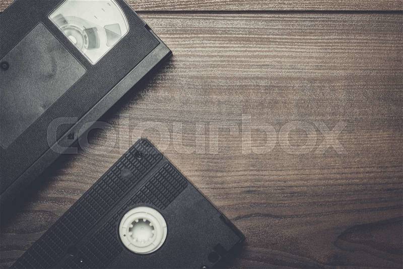 Old retro video tape on the wooden background, stock photo
