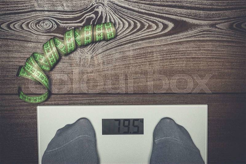 Grey electronic scales on the wooden floor dieting concept, stock photo