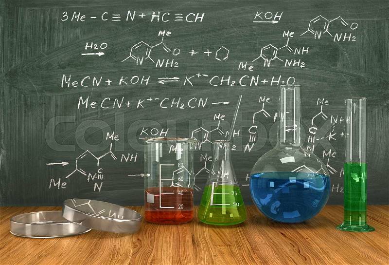 Test-tubes with various acids and other chemicals on the background of the blackboard, organic chemistry concept, stock photo