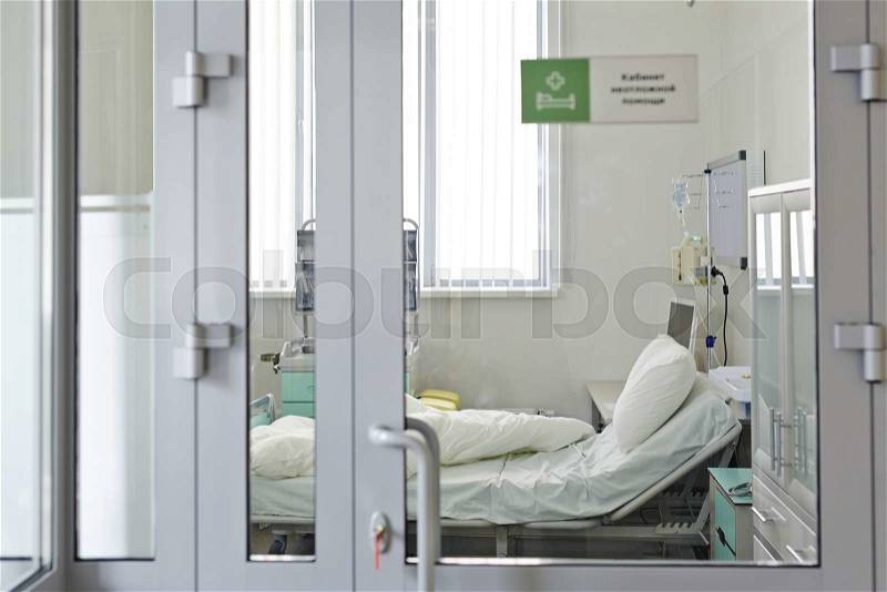 Intensive care unit behind closed glass door, stock photo