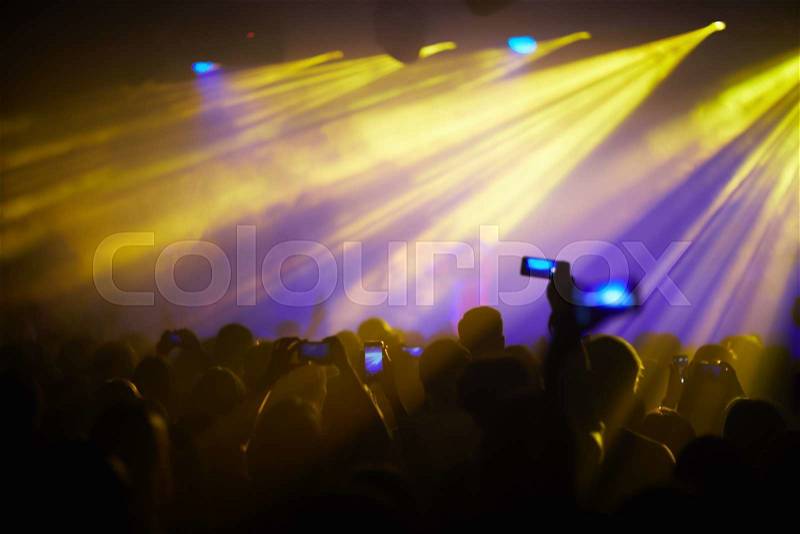 Modern people recording live performance of their favorite singer on smartphones, stock photo