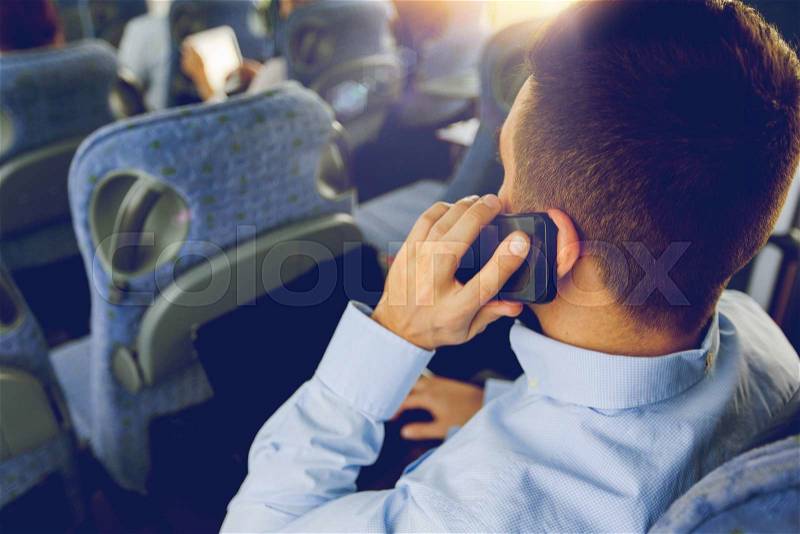 Transport, tourism, business trip and people concept - close up of man with smartphone and laptop calling in travel bus, stock photo