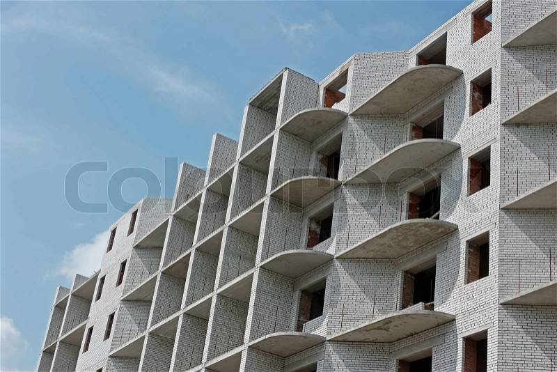Building during construction on the background of blue sky, stock photo