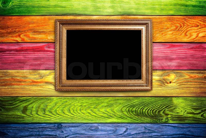 Old vintage frame on a color wooden backgound, stock photo