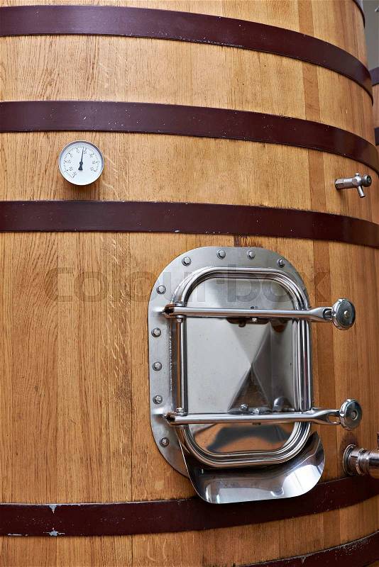 Wooden tank barrel for aging wine at the winery, stock photo
