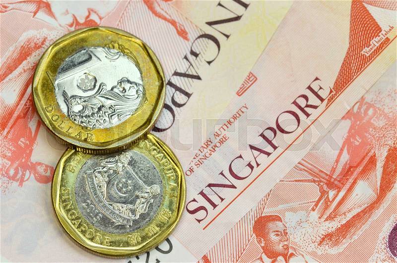 Singapore money on white background. One dollar coins and ten dollar banknote, stock photo