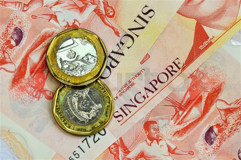 Singapore money on white background. One dollar coins and ten dollar banknote, stock photo