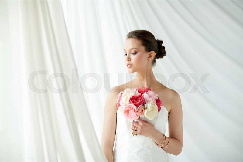 Beauty, jewelry, people and luxury concept - beautiful asian woman or bride in white dress with peony flower, golden ring and bracelet, stock photo