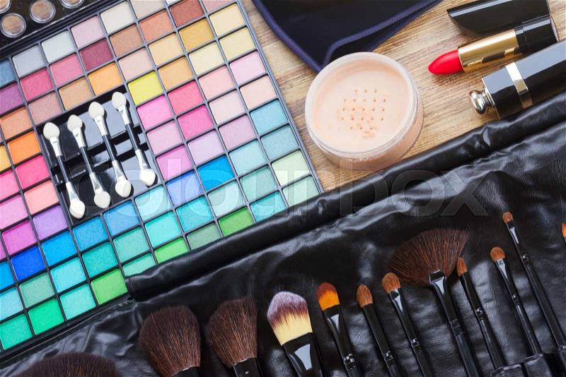 Set of professional black brushes with eye shadows, powder and lipsticks, stock photo