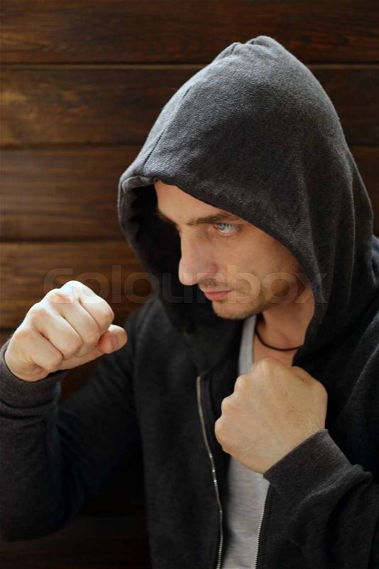 Portrait of blonde man with blue eyes in the hood, stock photo