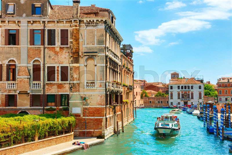 Grand Canal in Venice with houses and traveling people on voat, stock photo