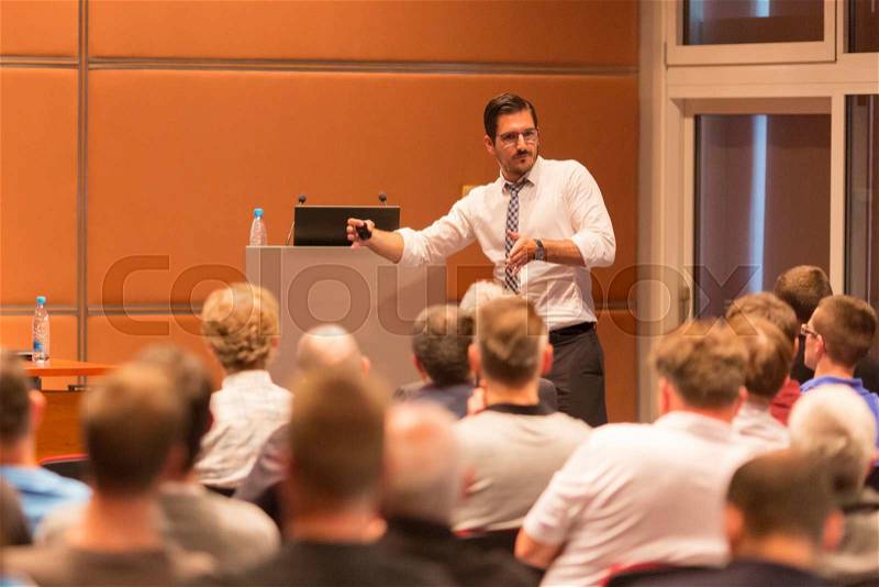 Speaker giving a talk in conference hall at business event. Audience at the conference hall. Business and Entrepreneurship, stock photo