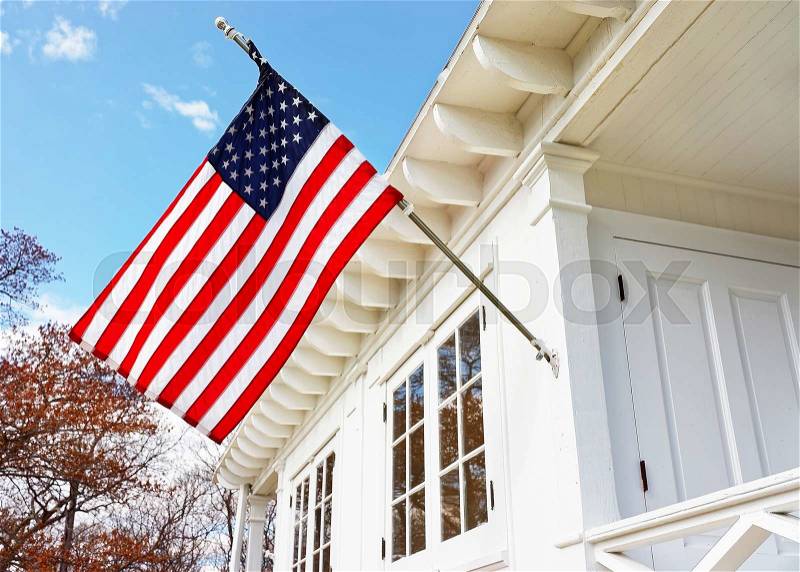 American flag on Sandy Hook Light house museum. It is the oldest lighthouse still working now. Sandy Hook is located in Highlands in Monmouth County of New Jersey, USA. Selective focus, stock photo