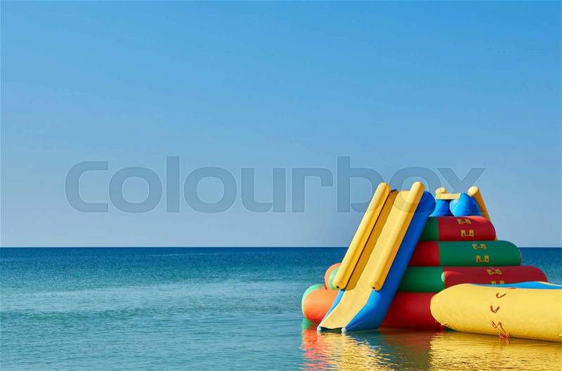 Water inflatable slide attraction. recreation concept on the water, stock photo