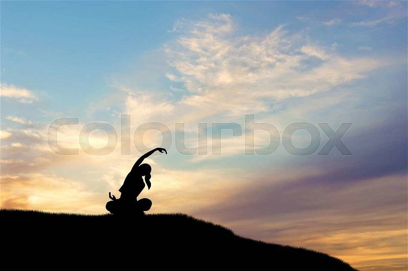 Yoga concept. Silhouette of woman doing yoga at sunset, stock photo