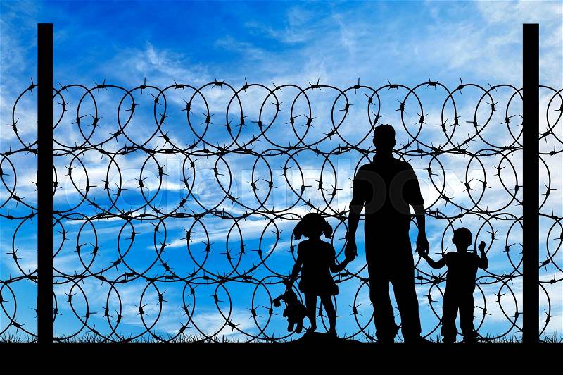 Silhouette of a family with children of refugees and fence with barbed wire on the background of the beautiful sky, stock photo