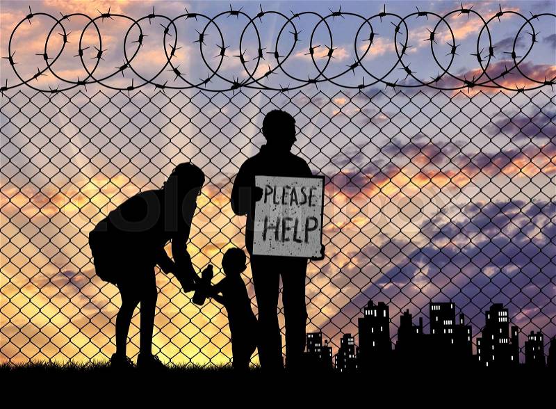 Concept of the refugees. Silhouette of a refugee family with a child near the fence at sunset asking for help, stock photo