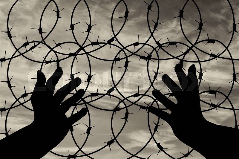 Concept of religion is a refugee. Silhouette of praying hands of an appeal to the sky, stock photo