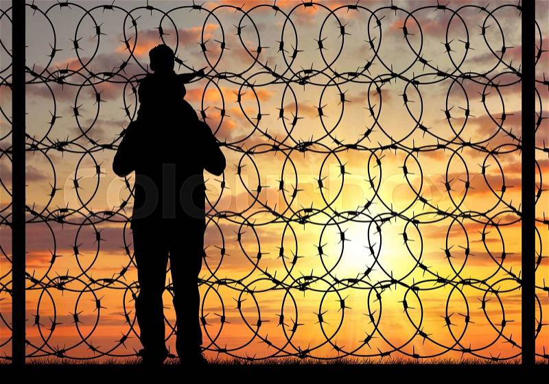 Concept of refugee. Silhouette of a family with a child refugee father near the fence with barbed wire at sunset, stock photo