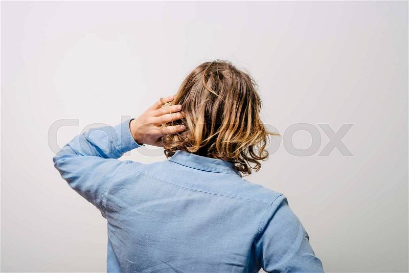 Young man . Back view. On a gray background, stock photo