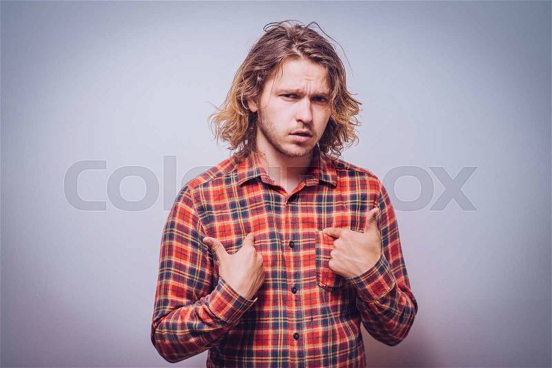 Male hand forefinger pointing to himself on the chest. Gesture. who am i. On a gray background, stock photo