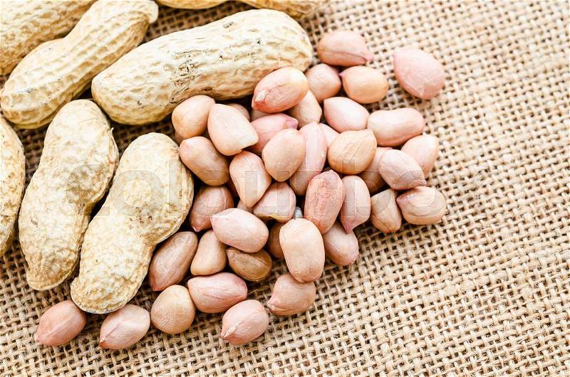 Peeled peanut on well peanuts, stock photo