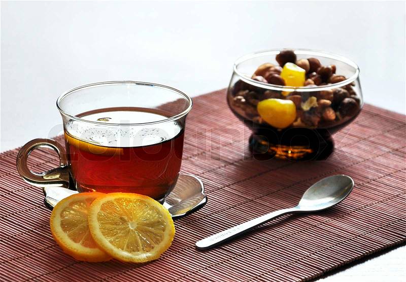 Cup of tea with lemon and mix of nuts, stock photo