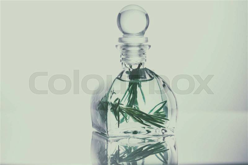 Rosemary essential oil in a glass bottle, Aroma oil, stock photo