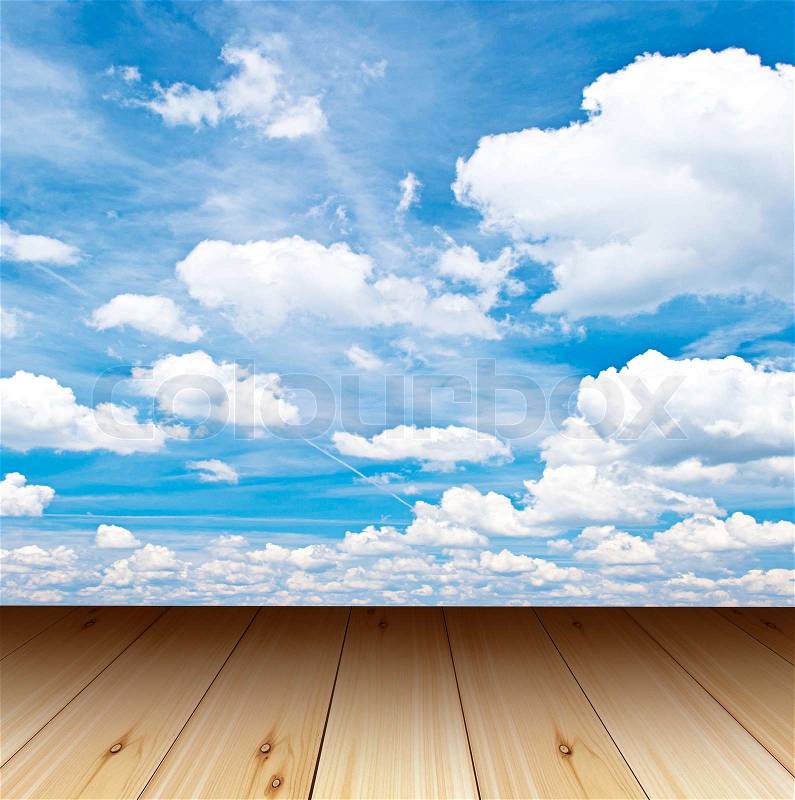 Wooden terrace with view of cloudy blue sky, stock photo