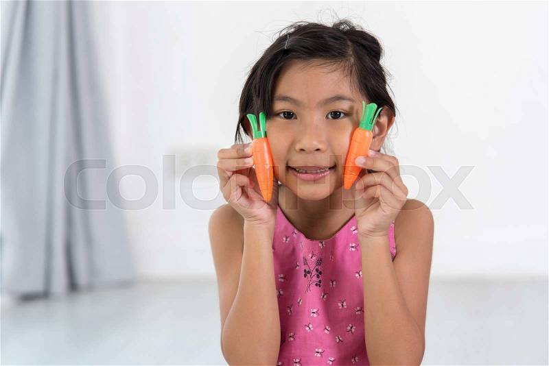 Asian child playing a chef at home, stock photo